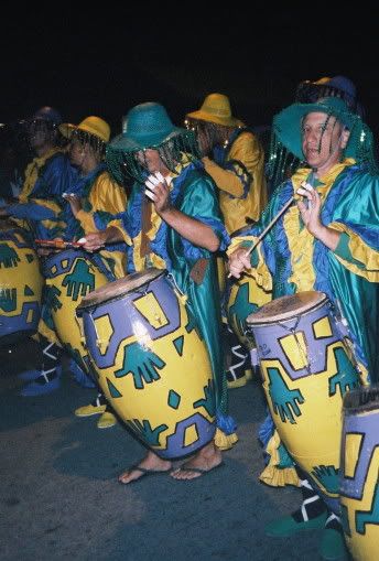 The drummers pass by the camera