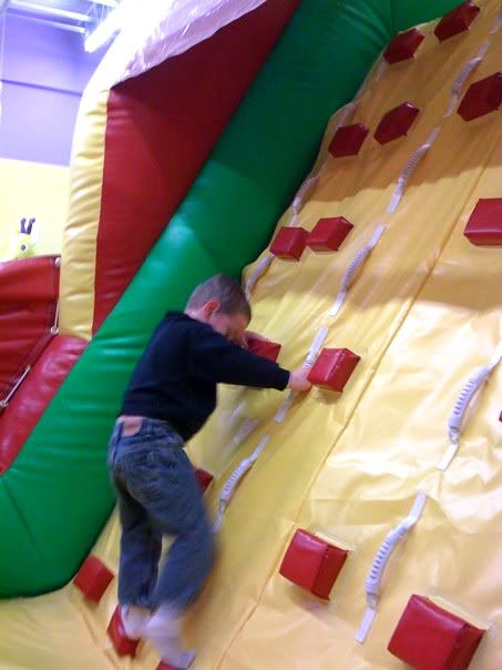 Landon climbs the end of the obstacle course