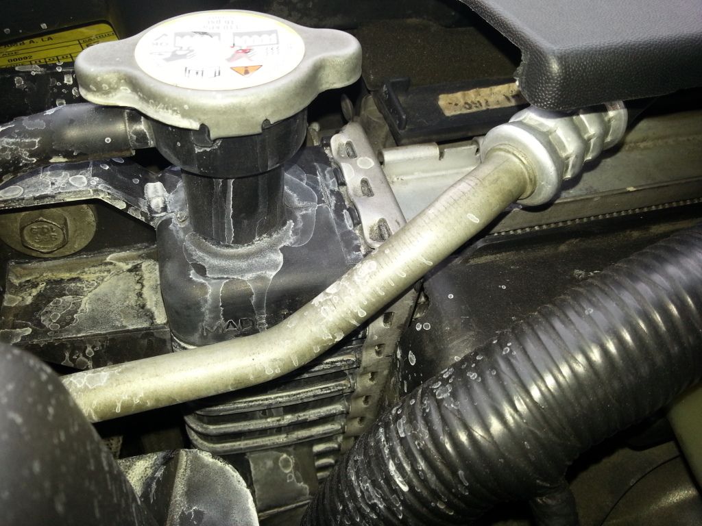 Leaking coolant...looks like squirting from the radiator cap. Ford