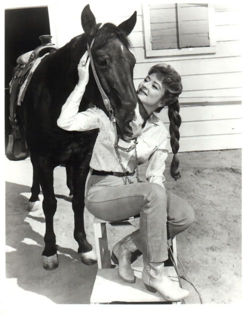 Amanda Blake is nuzzled by a fe...